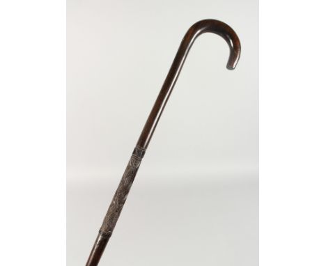 A NATIVE WALKING STICK with crosshatch carving. 3ft 3ins long.