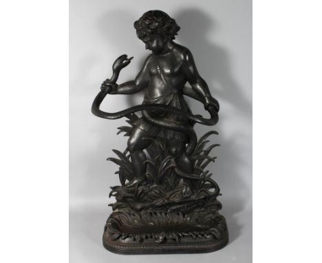 A GOOD LATE 19TH CENTURY CAST IRON STICK STAND, of classical form, cast as a young man wrestling with a snake. 33.5ins high.