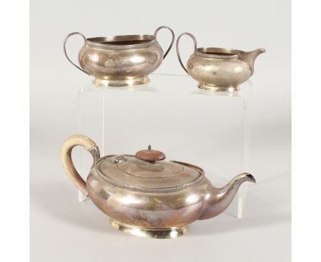 AN OVAL SILVER TEAPOT, SUGAR BASIN AND MILK JUG. Birmingham 1932 and London 1928.  Gross Weight: 20ozs.