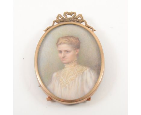 M* D*, A Young Lady, head and shoulders length, signed and dated 1903, oval portrait miniature, ina gilt frame, overall 9cm x