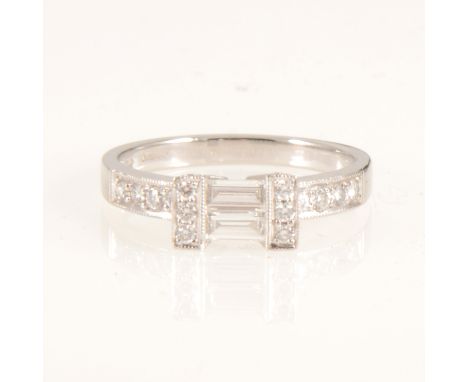A diamond baguette cut ring with brilliant cut shoulders, the two baguette cut diamonds set horizontally and held by three br