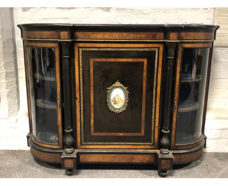 Victorian burr walnut and&nbsp;ebonised&nbsp;credenza, moulded edge, bow front, the door with an oval Sevres style porcelain 