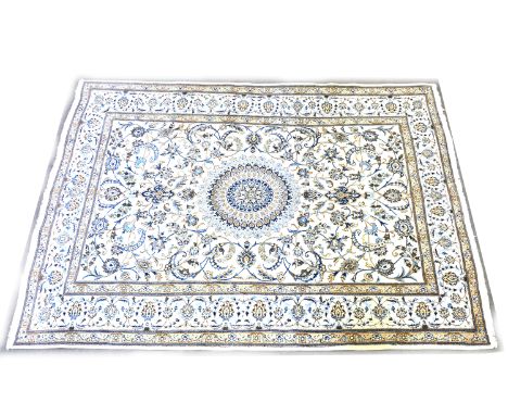 Nairn wool carpet, central medallion on a scrolled ivory coloured field, border within guards, 400cm x 260cm