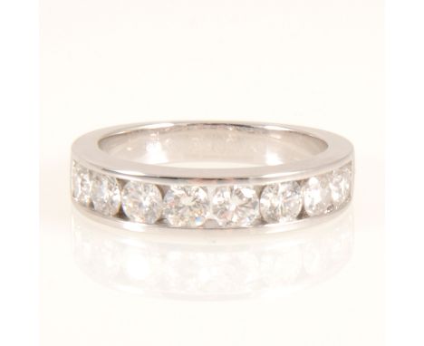 A diamond half eternity ring, eight brilliant cut diamonds channel set in an 18 carat white gold mount 5mm wide at front, E.D
