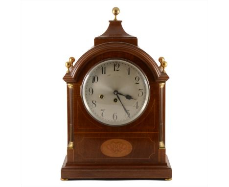 An Edwardian inlaid mahogany mantel clock, silvered dial with Arabic numerals, Junghans movement, striking on a gong and four