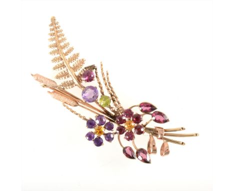 Alabaster &amp; Wilson - a multi gem set brooch in a floral design, the 9 carat yellow gold mount set with amethyst, almandin