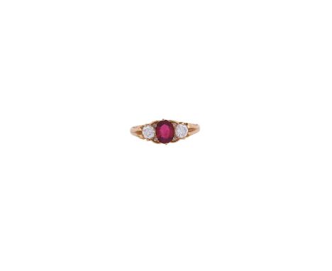 AN 18 CARAT GOLD RUBY AND DIAMOND THREE STONE RING  LONDON 1998The oval cut ruby estimated to weigh 0.94 carats, flanked by t