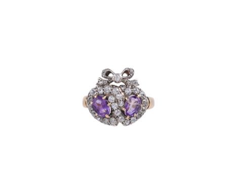 A DIAMOND AND AMETHYST DOUBLE HEART RINGThe double heart shaped panel centred with oval cut amethysts within a border of old 