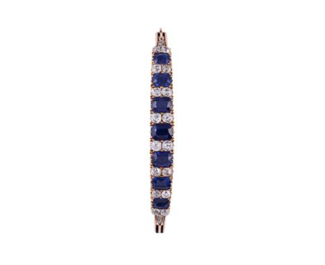 A LATE VICTORIAN SAPPHIRE AND DIAMOND HINGED BANGLE, BASALTIC, NO HEAT CIRCA 1890The bangle with graduated rectangular cushio