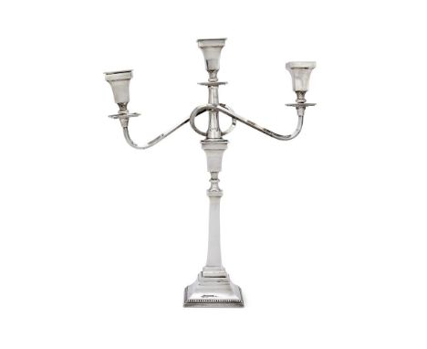 A SILVER THREE LIGHT CANDELABRAALBERT SYDENHAM, BIRMINGHAM 1960With square sconces, tapering capitals, twin scroll branches, 