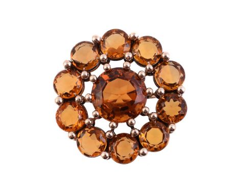 A MID 20TH CENTURY CITRINE CLUSTER BROOCHThe central circular cut citrine within a surround of circular cut citrines with bea