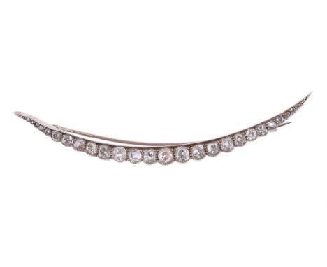 AN EARLY 20TH CENTURY DIAMOND CRESCENT BROOCH CIRCA 1900The crescent millegrain set with graduated old mine cut diamonds, wit