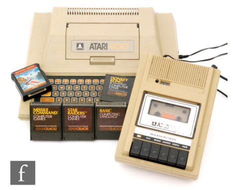 An Atari 400 computer with Program Recorder and five cartridges to include Donkey Kong, Star Raiders and River Raid, unboxed.