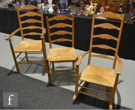 A set of eight 20th Century ash ladder back rush seat dining chairs and a matching rocking chair. (9) 