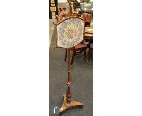 A William IV rosewood pole screen, with tapestry panel over a trefoil shaped base, height 137cm, S/D. 