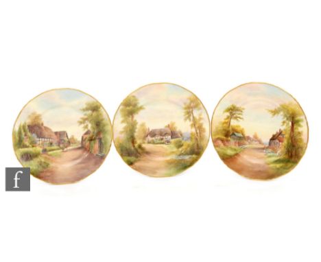 A collection of three Royal Worcester cabinet plates decorated by R. Rushton with scenic views in gilded borders, comprising 