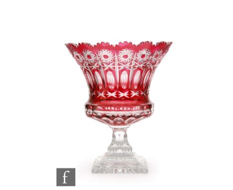 An early 20th Century Stourbridge crystal pedestal bowl with a square stepped base rising to a bell form bowl with petal edge