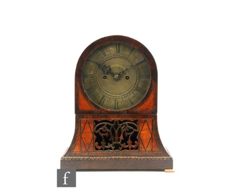 A 19th Century and later rosewood and satinwood veneered arch shaped mantel clock, raised to brass feet, with a later associa