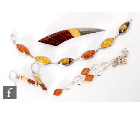 A modern silver mounted Baltic amber six panel bracelet with similar pair of drop earrings, a necklet and a crescent shaped b