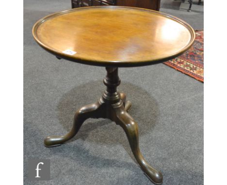 A 19th Century mahogany supper table of circular form, raised to a turned pedestal over a tripod base, later repairs height 5