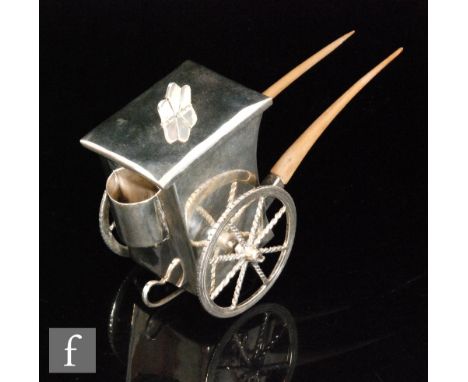 A novelty white metal tea caddy or sugar box, modelled as a rickshaw, unmarked, height 13cm and overall length 18cm. 