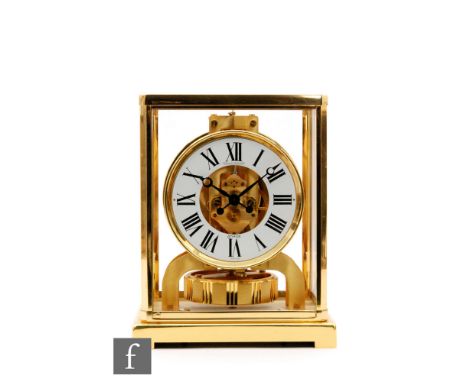 A Jaeger Le Coultre Atmos clock, the white dial with Roman numerals, in a lacquered brass and glazed case on bracket plinth, 