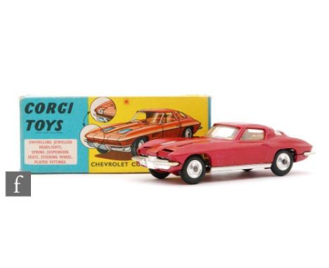 A Corgi Toys #310 Chevrolet Corvette Stingray diecast model in metallic cerise with yellow interior and spun hubs, in blue an