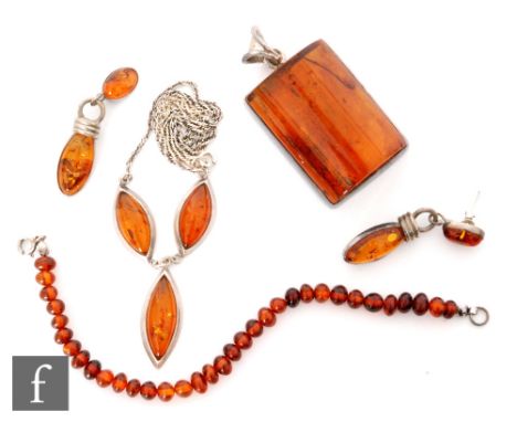 A modern silver mounted Baltic amber three panel necklet with similar pair of drop earrings, a large pendant and a bracelet s