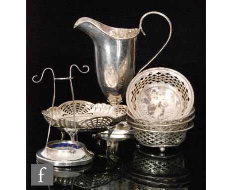 A hallmarked silver helmet cream jug with a set of four circular bon bon dishes and a similar oval dish, total weight 10oz, v