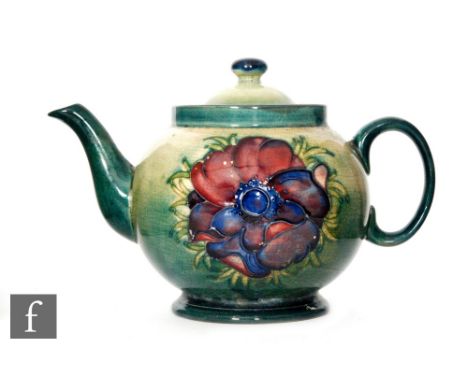 A Moorcroft circular box and cover in the Hibiscus pattern, with tubelined flowers against the green wash ground, diameter 14