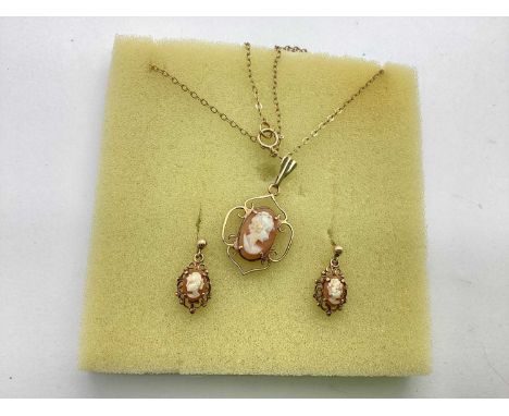 A Pair of 9ct Gold Carved Cameo Drop Earrings, the carved oval panel depicting the portrait of a lady, within decorative scro