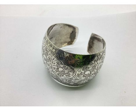 A Vintage Style Highly Decorative Wide Cuff Bangle, of tapered form with allover scrolling foliage design, stamped "STERLING 