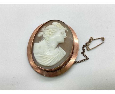 An Antique Carved Shell Cameo Panel Brooch, the oval panel depicting the side profile of a lady, collet set within plain oval