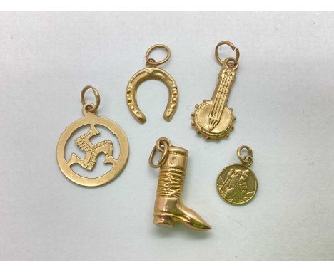 A Small Collection of 9ct Gold Novelty Charms, including banjo, riding boot, horseshoe, St. Christopher, together with an isl