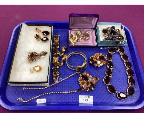 A Selection of Ornate Costume Jewellery, including gilt coloured claw set brooches, clip on drop earrings, panel style bracel