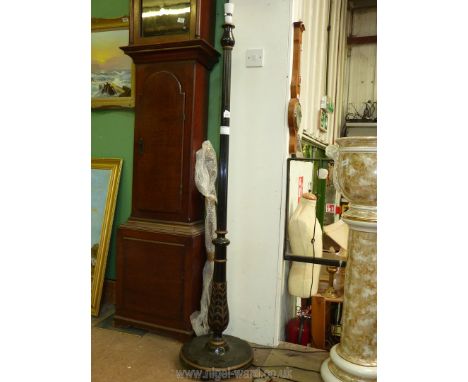 An ebonised and gilt detailed standard Lamp, having a turned and reeded column with stylised foliage near the base and raised