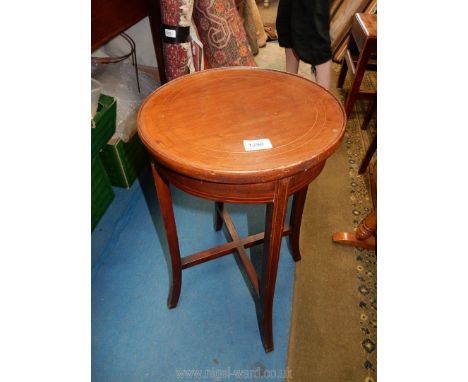 An Edwardian Mahogany occasional/lamp Table having lightwood strining, the swept legs united by a cross stretcher, 12 1/2'' d