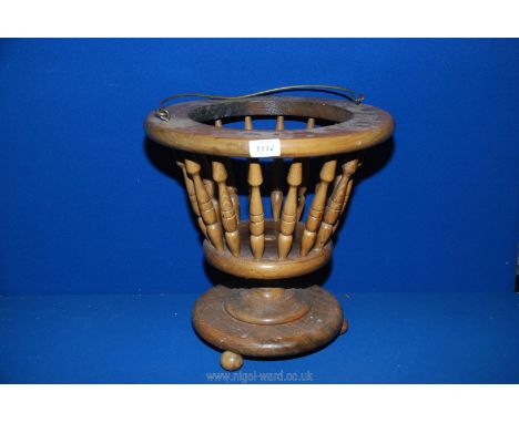 A lightwood circular jardiniere Stand with bobbin turned spindle sides, 15" tall inner rim 10'' diameter.