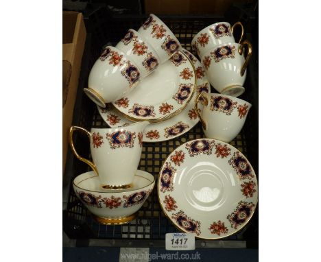 A Royal Imperial tea set for six with panels of blue, red and gold with sprays of flowers, no teapot.