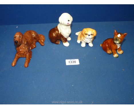 Four dog figurines to include a Goebel West German brown and white sheep dog and a boxer puppy, a Sylvac Pekinese dog and a B
