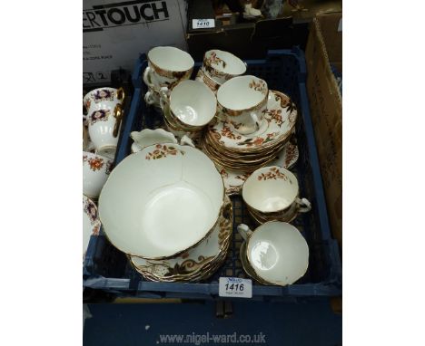 An old tea service with light brown and black flowers and foliage with gold highlights, some cracks and discolouration.