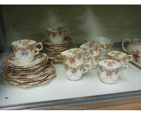 An Aynsley tea set with rose garland decoration (no teapot or milk jug).