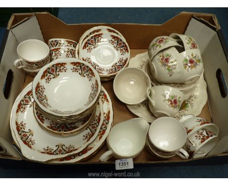 A Colclough part dinner services in orange, beige, and blue floral motif pattern to include dinner plates, cups (some with br