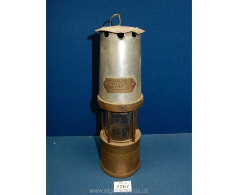 A miner's lamp by J.H. Naylor Ltd; Wigan (glass cracked), 10 1/2'' tall.