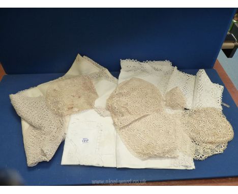 A small quantity of vintage lace work, broderie anglaise tablecloth, place settings, doilies etc.
