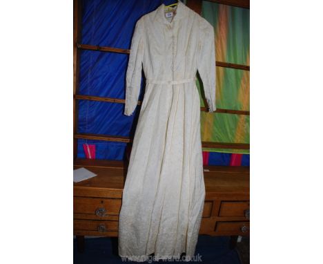 A cream coloured hand-made wedding Dress with a fourteen-button front and side zip with matching belt, size small, some marks