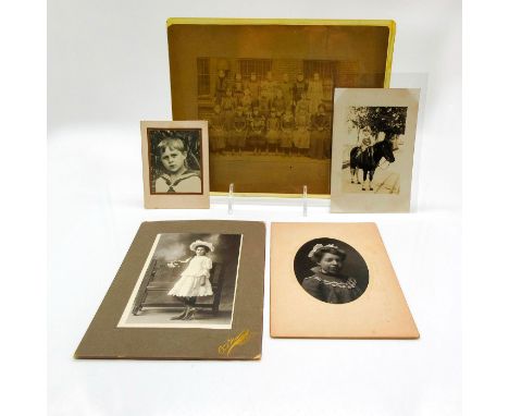 Featuring a class photo with children and instructor, two portrait photos of young girls, a photo of a little boy with nautic