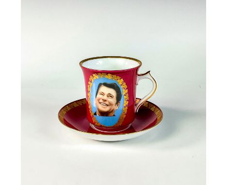 Cup features portrait of President Reagan, surrounded by gold wreath. Gold trim to rim and handles. Kaiser backstamp.Dimensio