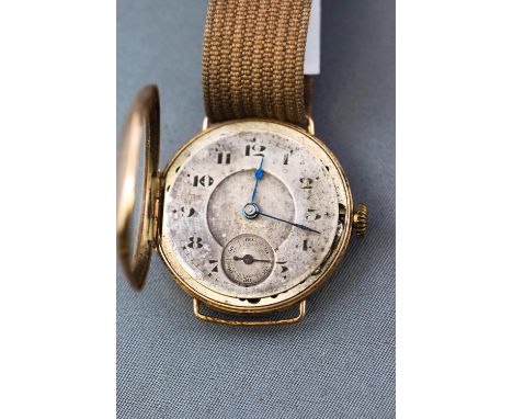 A yellow metal wristwatch having a cushion unbranded champagne dial (discoloured) with blued hands. Swiss made manual wind mo