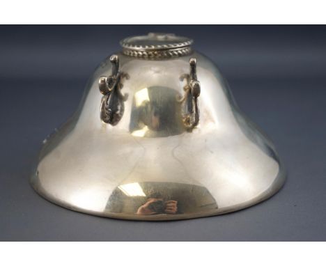 A silver inkwell, of flattened wide bell form, the flip up lid with a rope twist edge, set with a C scroll pen rest, Sheffiel